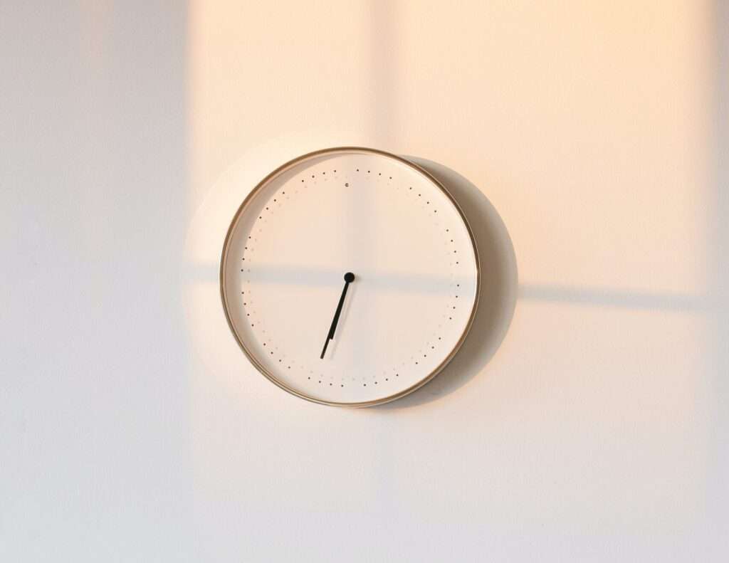 reloj blanco sobre pared blanca